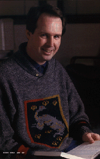 [38K GIF of Erik Fair holding a book]